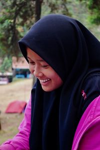 Close-up portrait of a smiling young woman