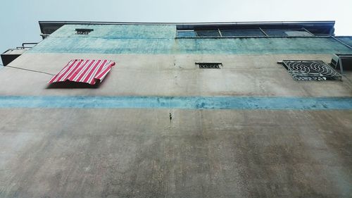Low angle view of clothes drying on building against sky