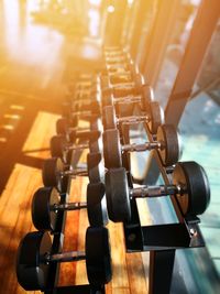 High angle view of dumbbells on rack in gym