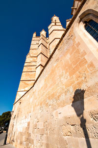 Low angle view of historical building against blue sky