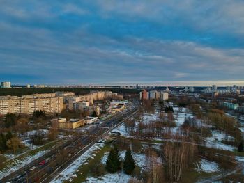 High angle view of road by buildings against sky