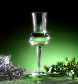 Close-up of glass on table against black background