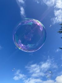 Low angle view of bubbles against sky