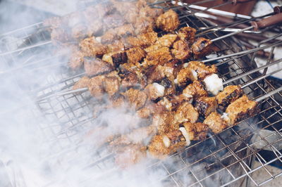High angle view of meat on barbecue grill