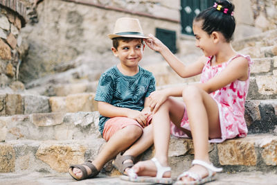 Cute sibling sitting on staircase