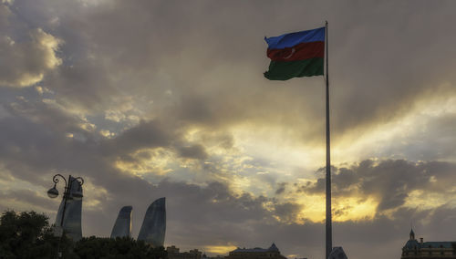 Low angle view of flag against cloudy sky