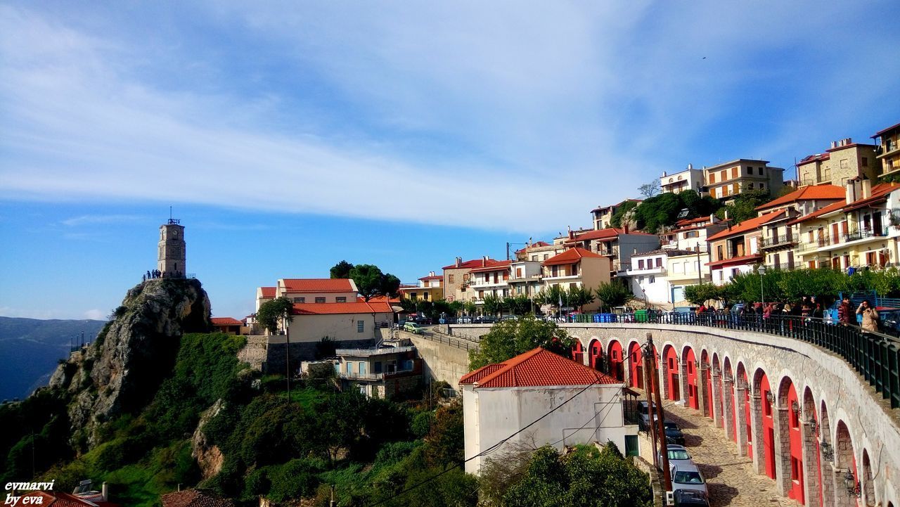 VIEW OF HOUSES IN TOWN AGAINST BLUE SKY