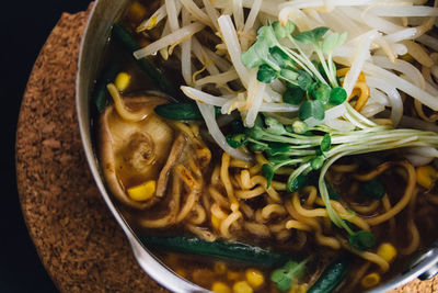 Close-up of fresh ramen noodles served in bowl on table