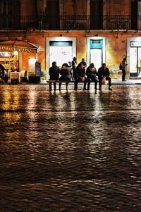 Group of people in illuminated building at night