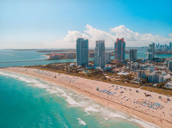 Aerial view of city and sea against sky