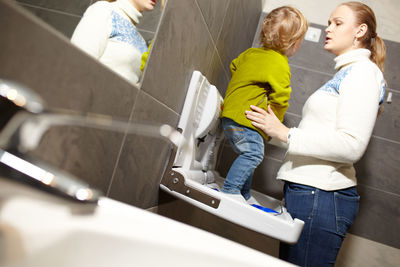 Mother and son in bathroom at home