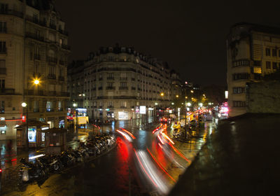 Traffic light trails on road in city at night
