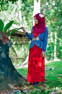 Rear view of woman standing in park