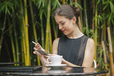 Young woman holding coffee cup