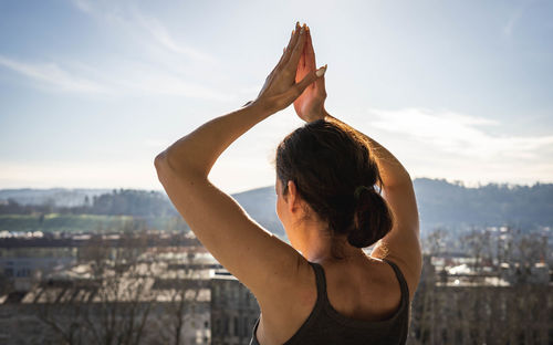 Woman raising her arms