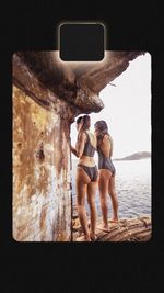 Rear view of couple photographing with mobile phone
