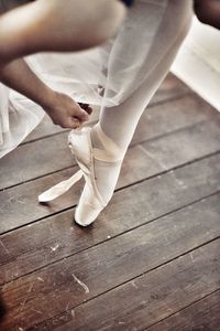 Low section of ballet dancer on floorboard