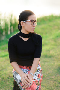 Mid adult woman sitting on tree stump