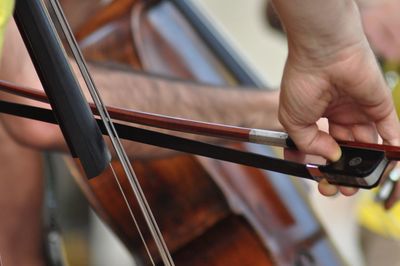 Cropped hands of man playing musical instrument