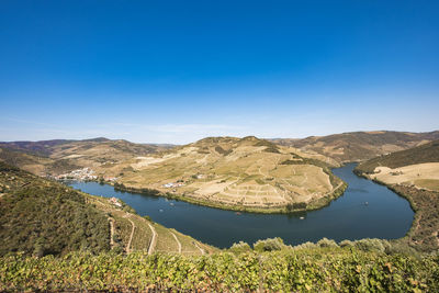 Scenic view of lake against blue sky