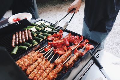 High angle view of man preparing food on barbecue grill