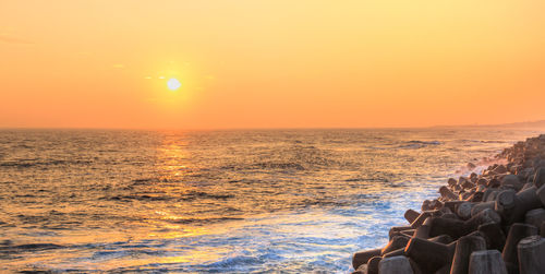 Scenic view of sea against clear sky during sunset