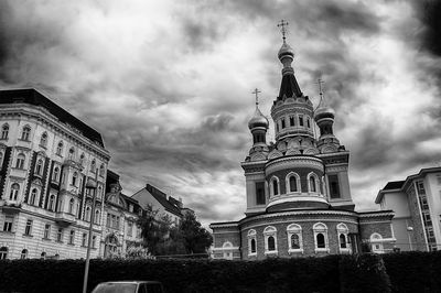 Low angle view of church against cloudy sky