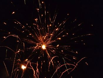 Low angle view of firework display at night