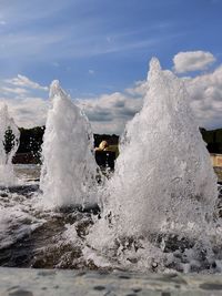 Water splashing in sea against sky