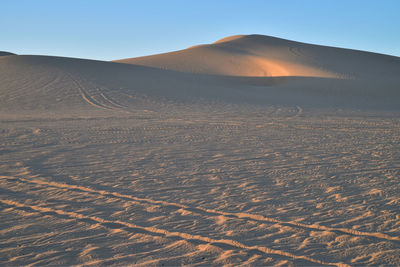 Aerial view of desert against clear sky