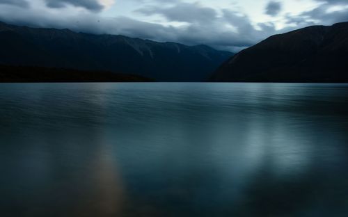 Scenic view of lake and mountains against sky