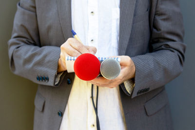 Midsection of man holding umbrella