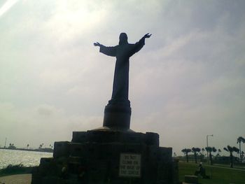 Low angle view of statue against cloudy sky