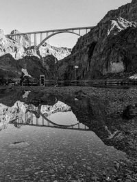 Arch bridge over river against sky