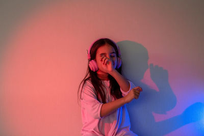 A dancing little girl in pink headphones