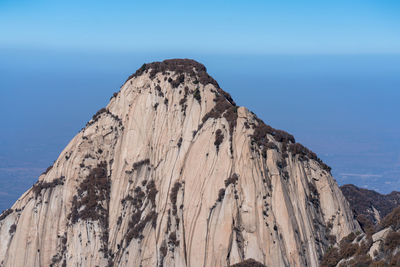 Low angle view of rock formations against sky