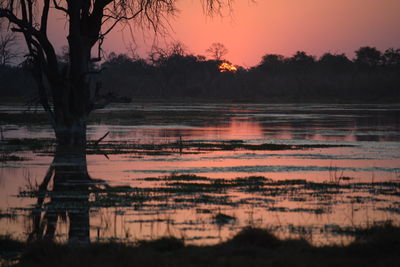 Scenic view of lake against sky during sunset