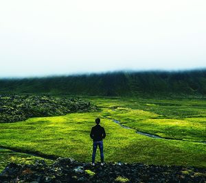 Full length of man on grass against sky