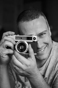 Close-up of photographer taking selfie