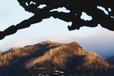 Scenic view of mountains against sky at sunset