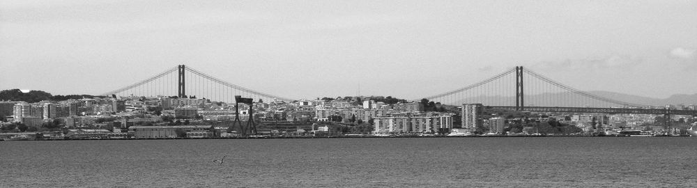 View of suspension bridge with city in background