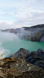 Scenic view of lake against cloudy sky