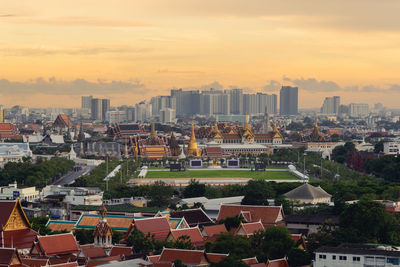 High angle view of buildings in city against sky during sunset