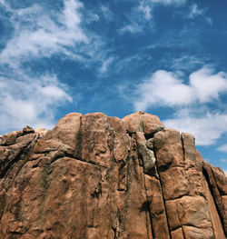 Low angle view of rock formation against sky