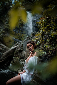 Portrait of young woman at forest