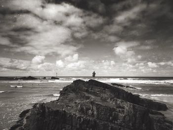 Scenic view of sea against cloudy sky