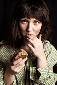 Portrait of a poor beggar woman eating bread