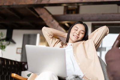 Portrait of young woman using digital tablet