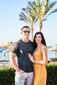 Portrait of young couple standing outdoors