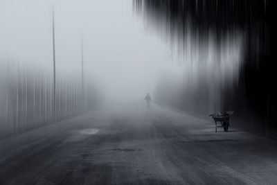 Blurred motion of people on road in foggy weather